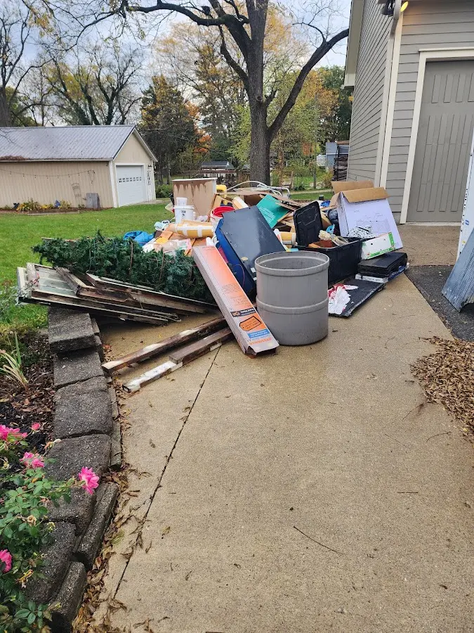 Dumpster being loaded with debris for Roofing Dumpster Rental in Conneaut